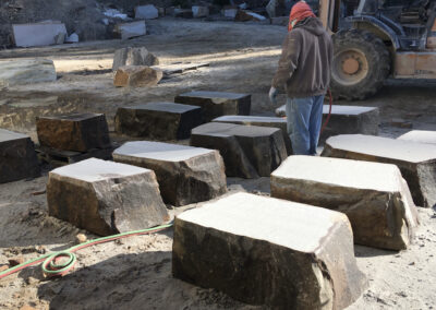 Park bench boulders lined up in the stoneyard